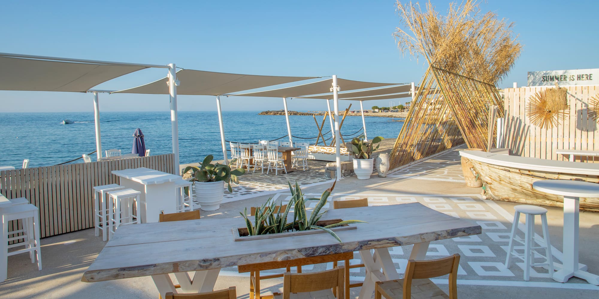 a table and chairs on a beach