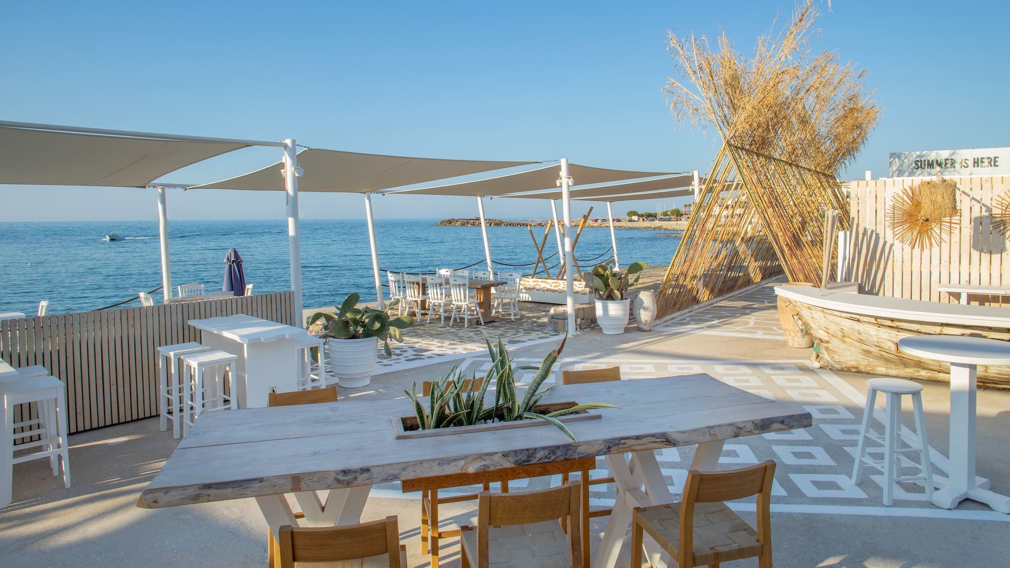 a table and chairs on a beach