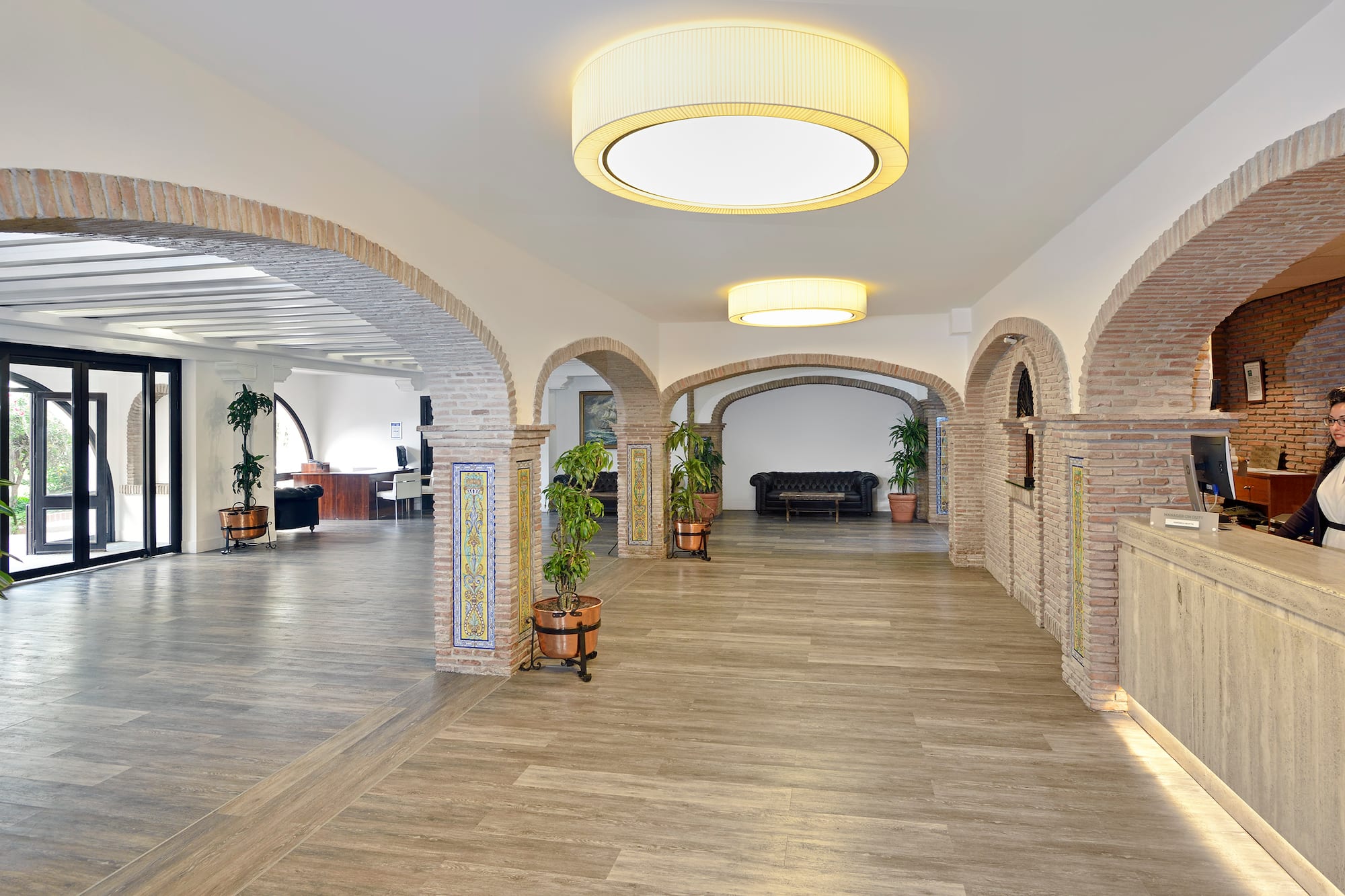 a room with a large brick archway and a couch