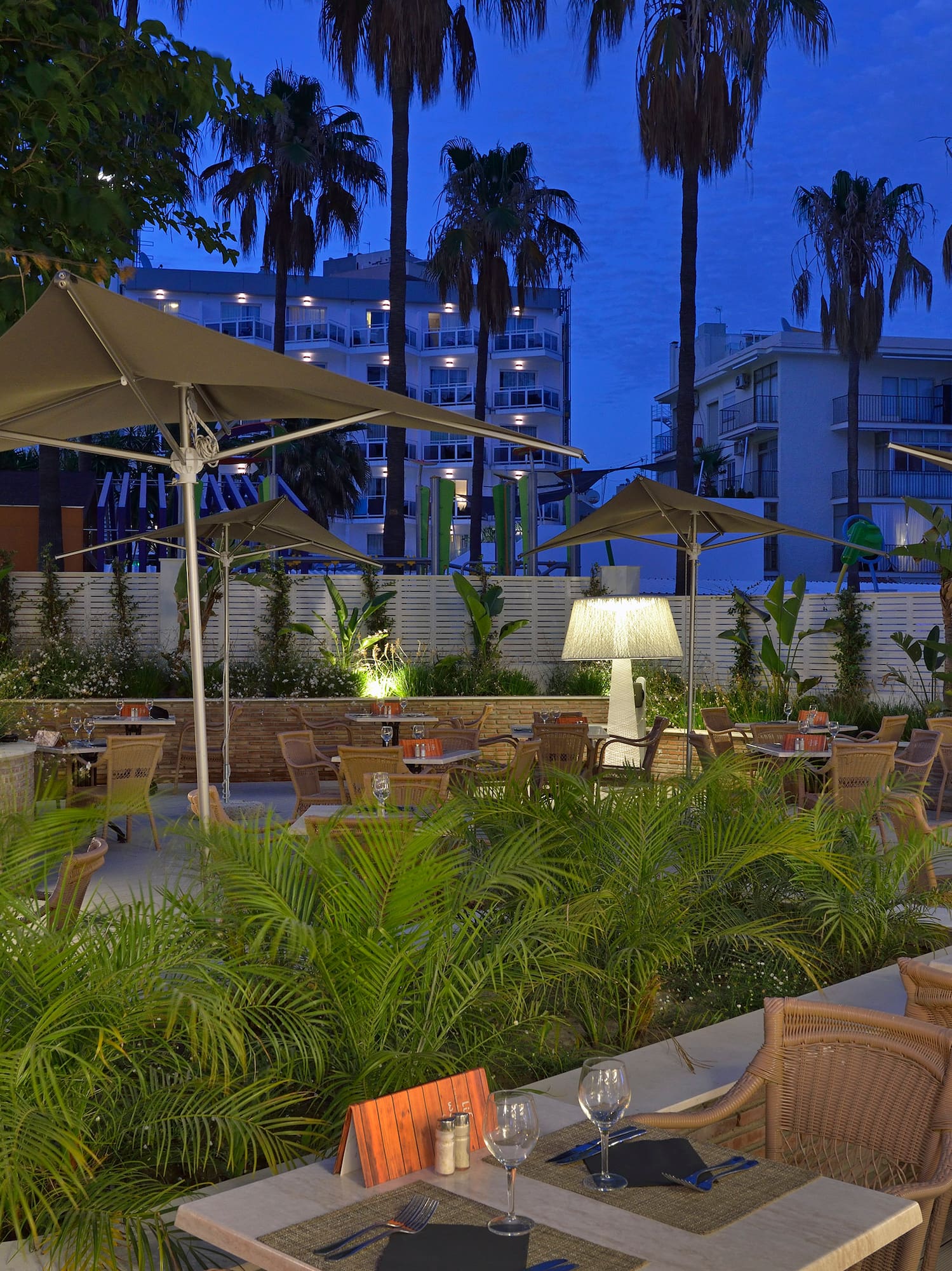 a patio with tables and chairs and umbrellas