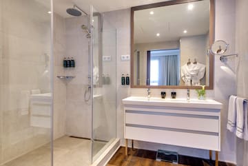 a bathroom with a shower and a sink