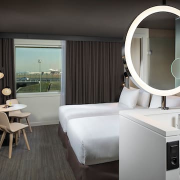 a room with two beds and a round light
