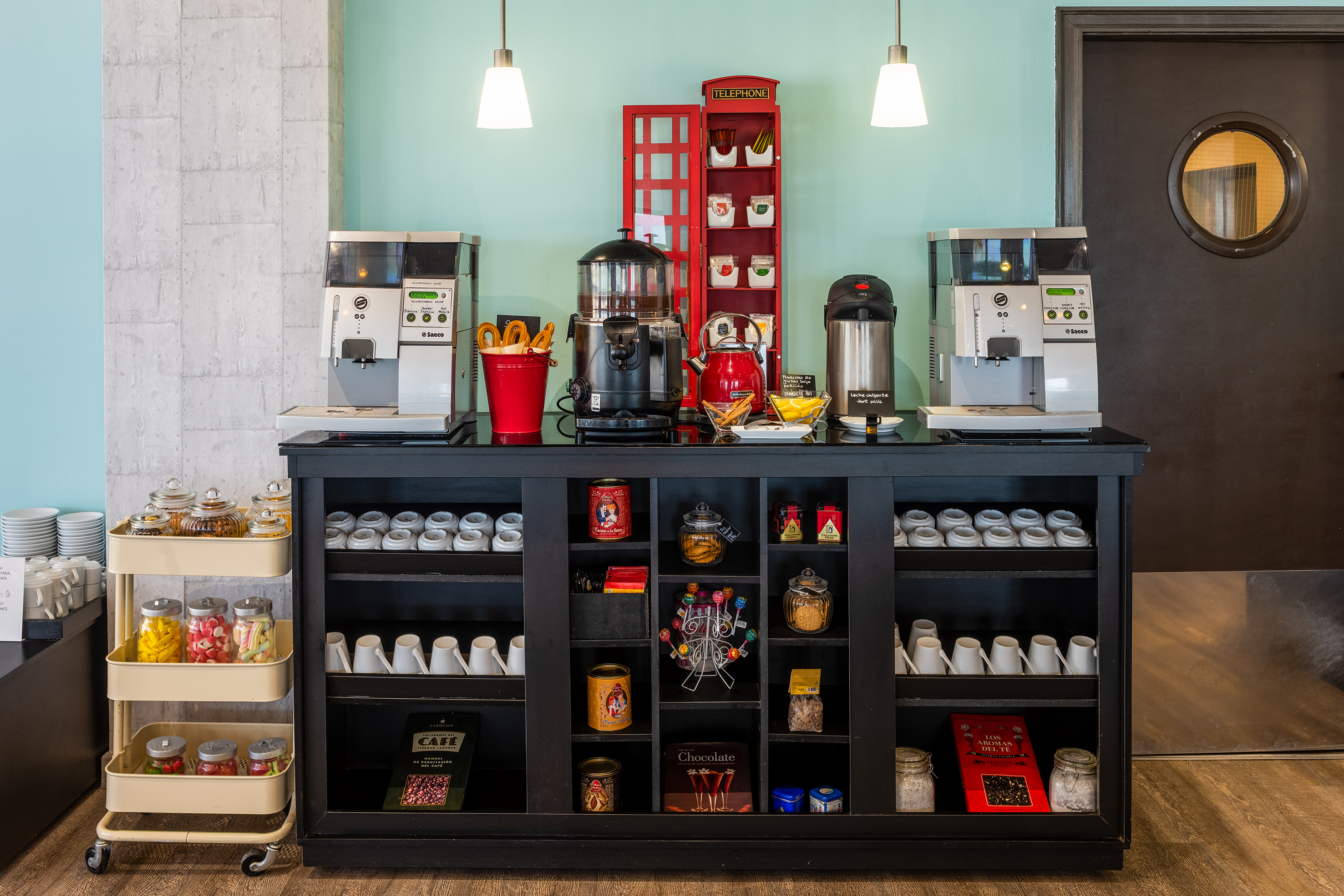 Hotel coffee and hot beverage station with Saeco machines, snacks, and sweets.
