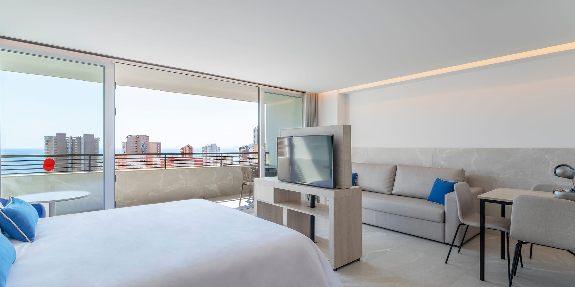 a bedroom with a television and a couch