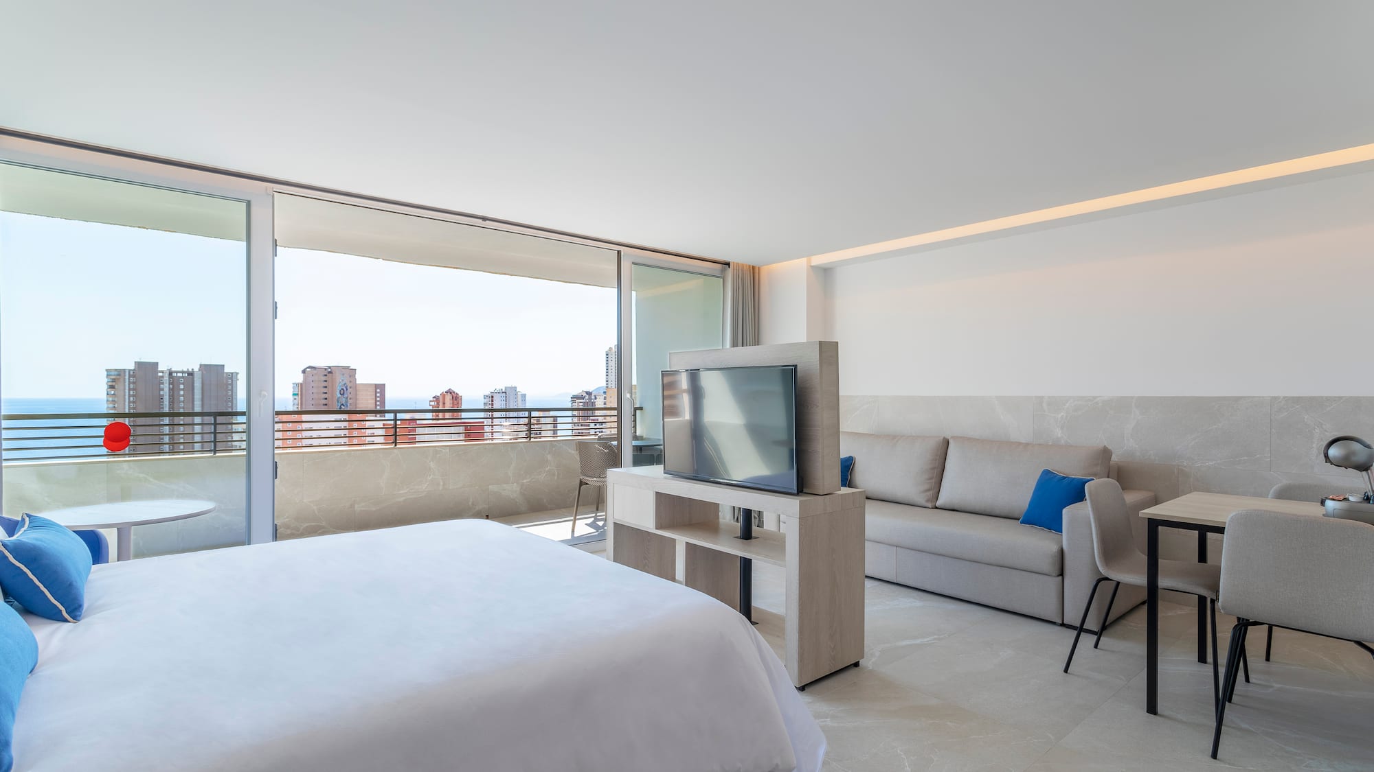 a bedroom with a television and a couch