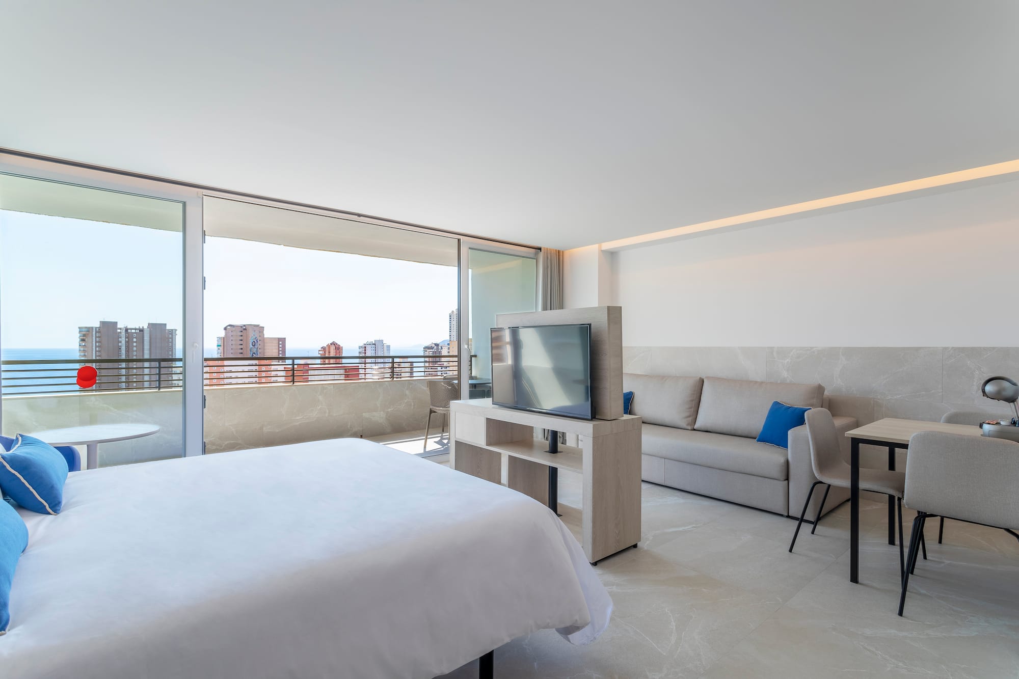 a bedroom with a television and a couch