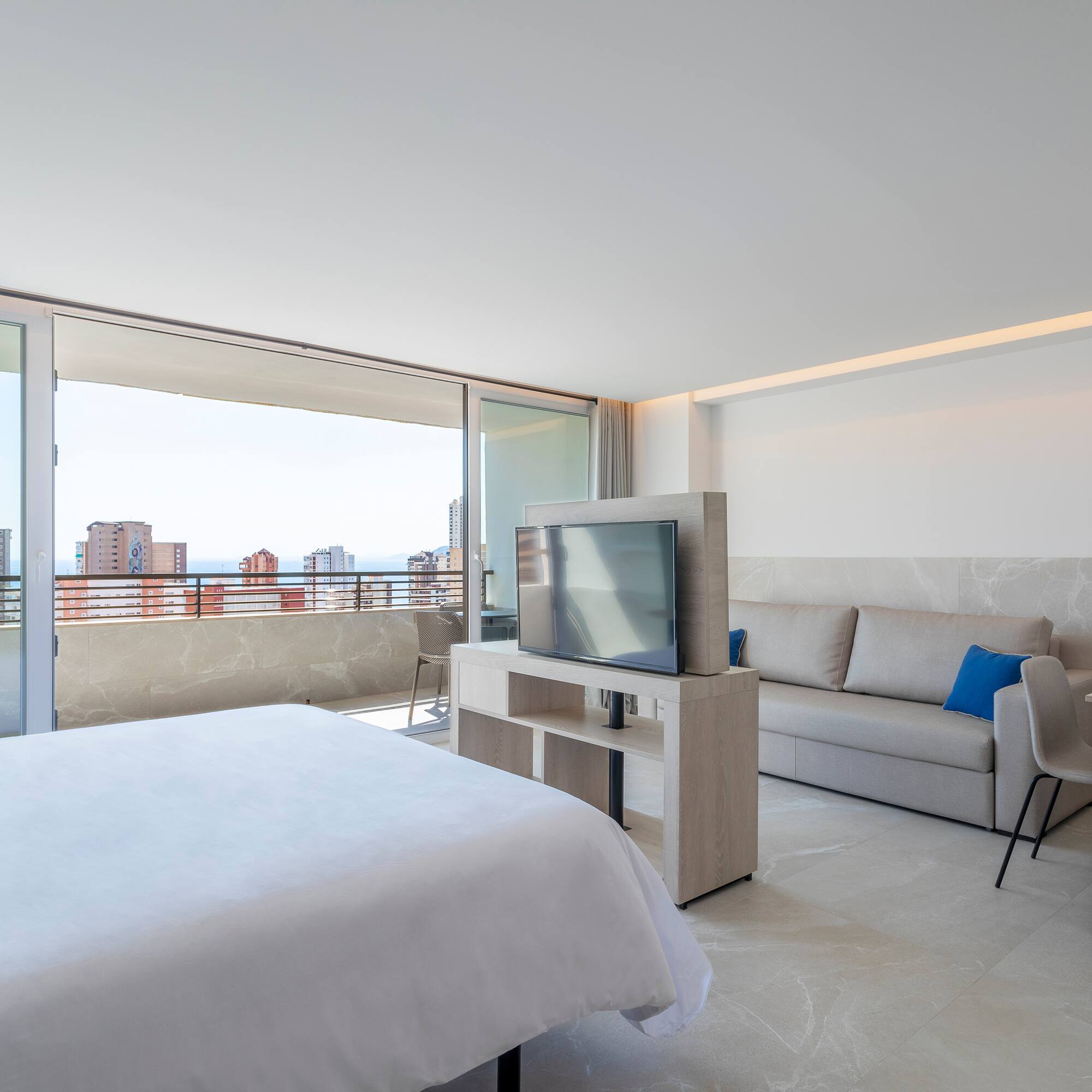 a bedroom with a television and a couch