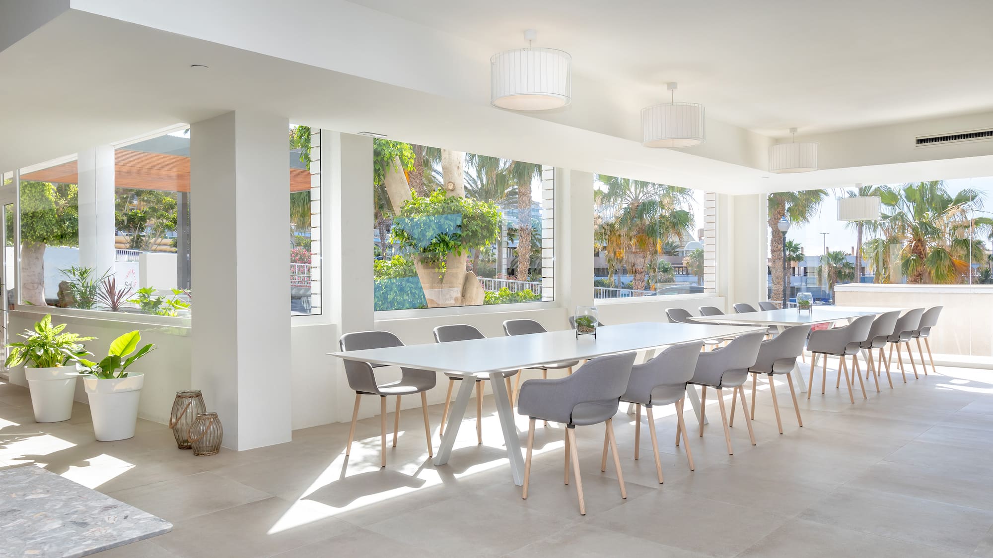 a room with a long table and chairs