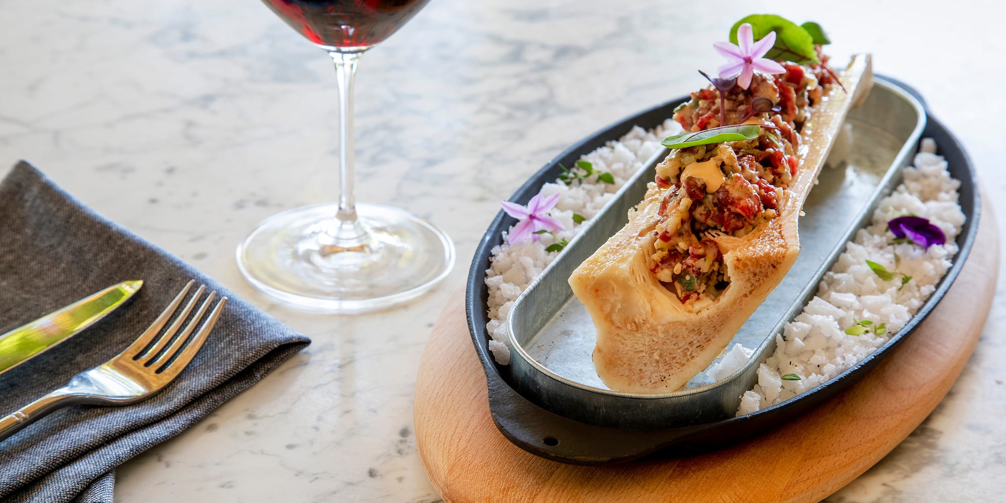 a plate of food and a glass of wine