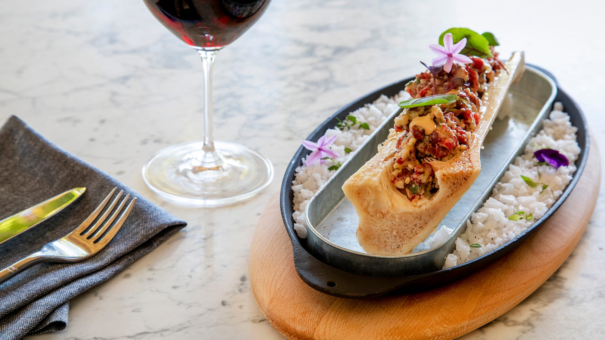 a plate of food and a glass of wine