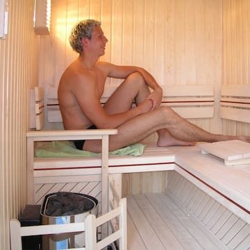a man sitting in a sauna