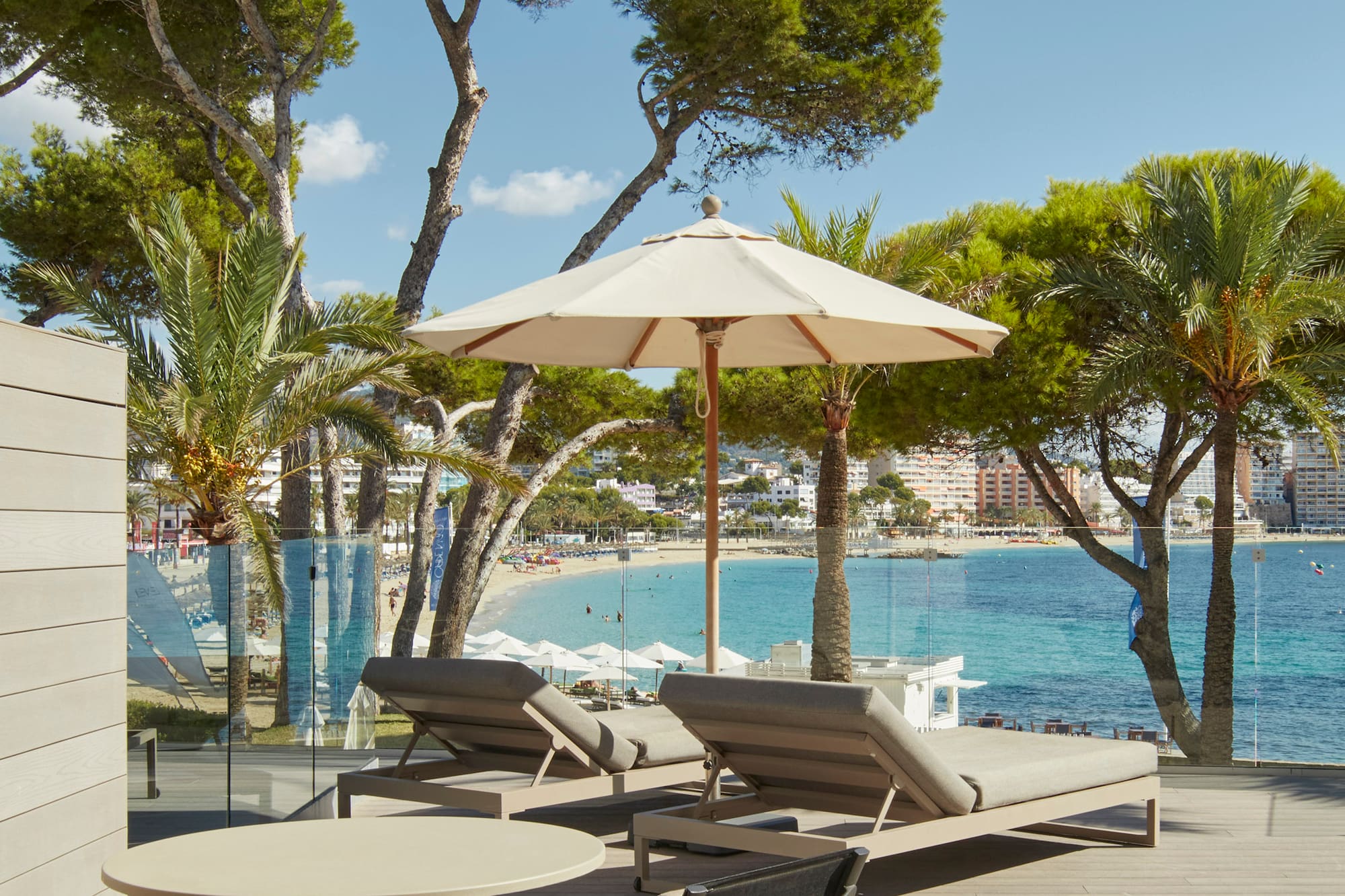 a deck with chairs and umbrellas by the water