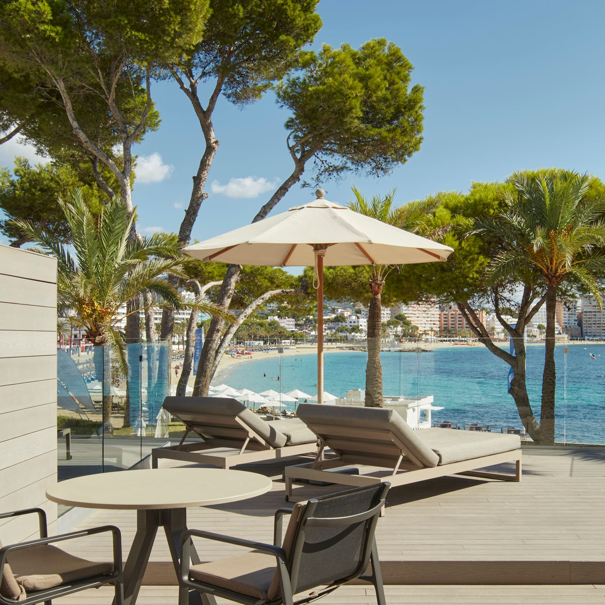 a deck with chairs and umbrellas by the water