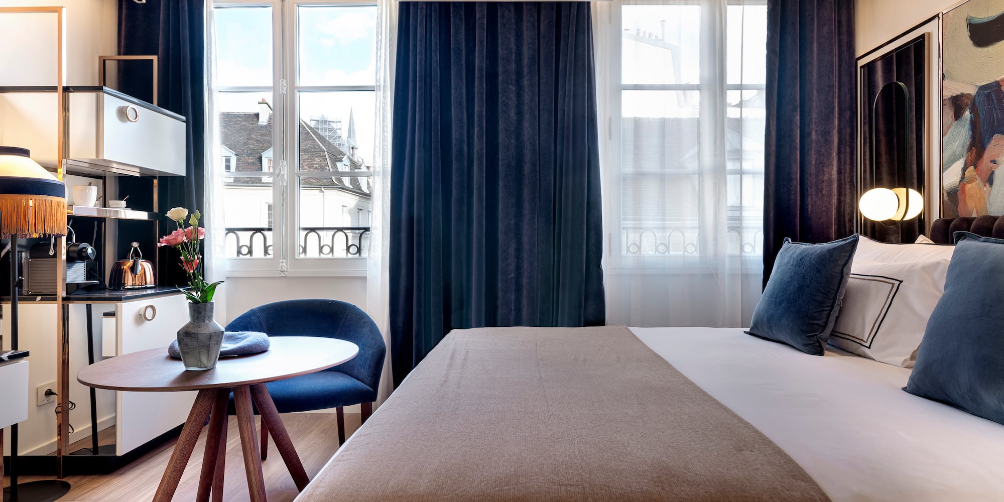 a bedroom with a bed and a table and chairs