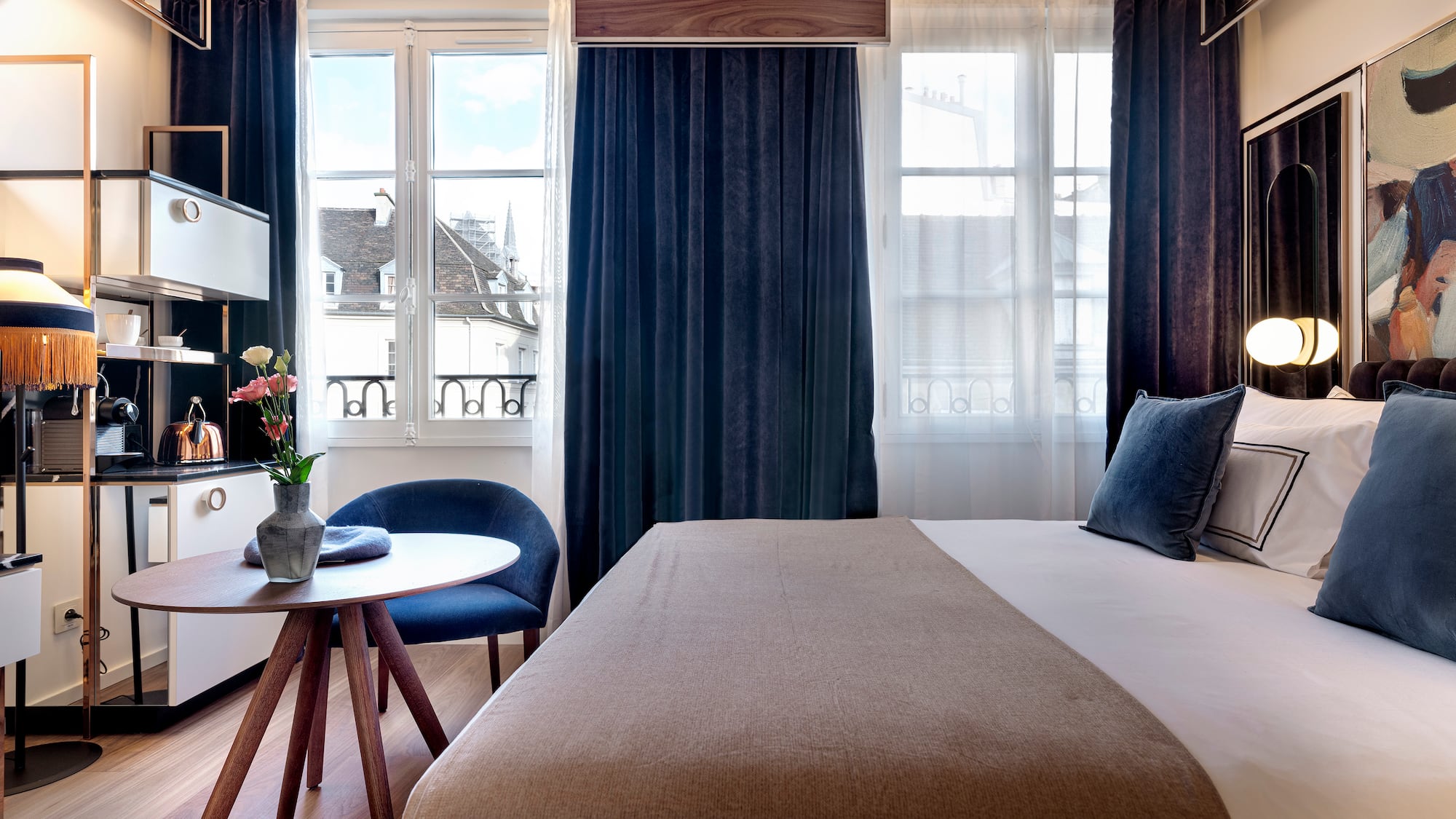 a bedroom with a bed and a table and chairs