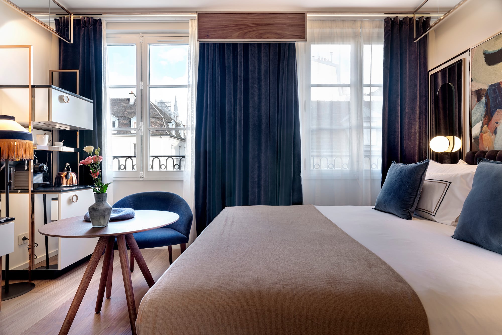 a bedroom with a bed and a table and chairs