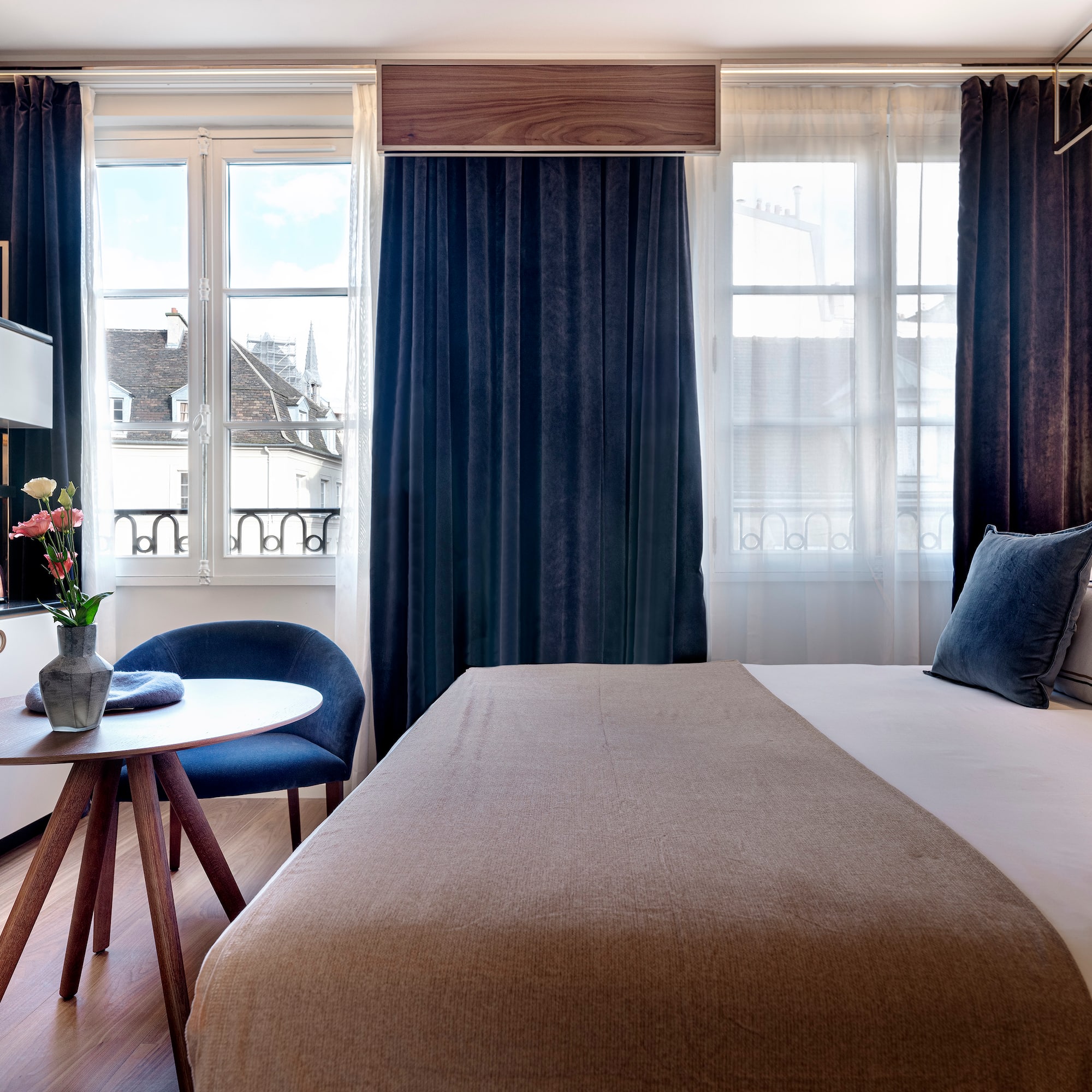 a bedroom with a bed and a table and chairs