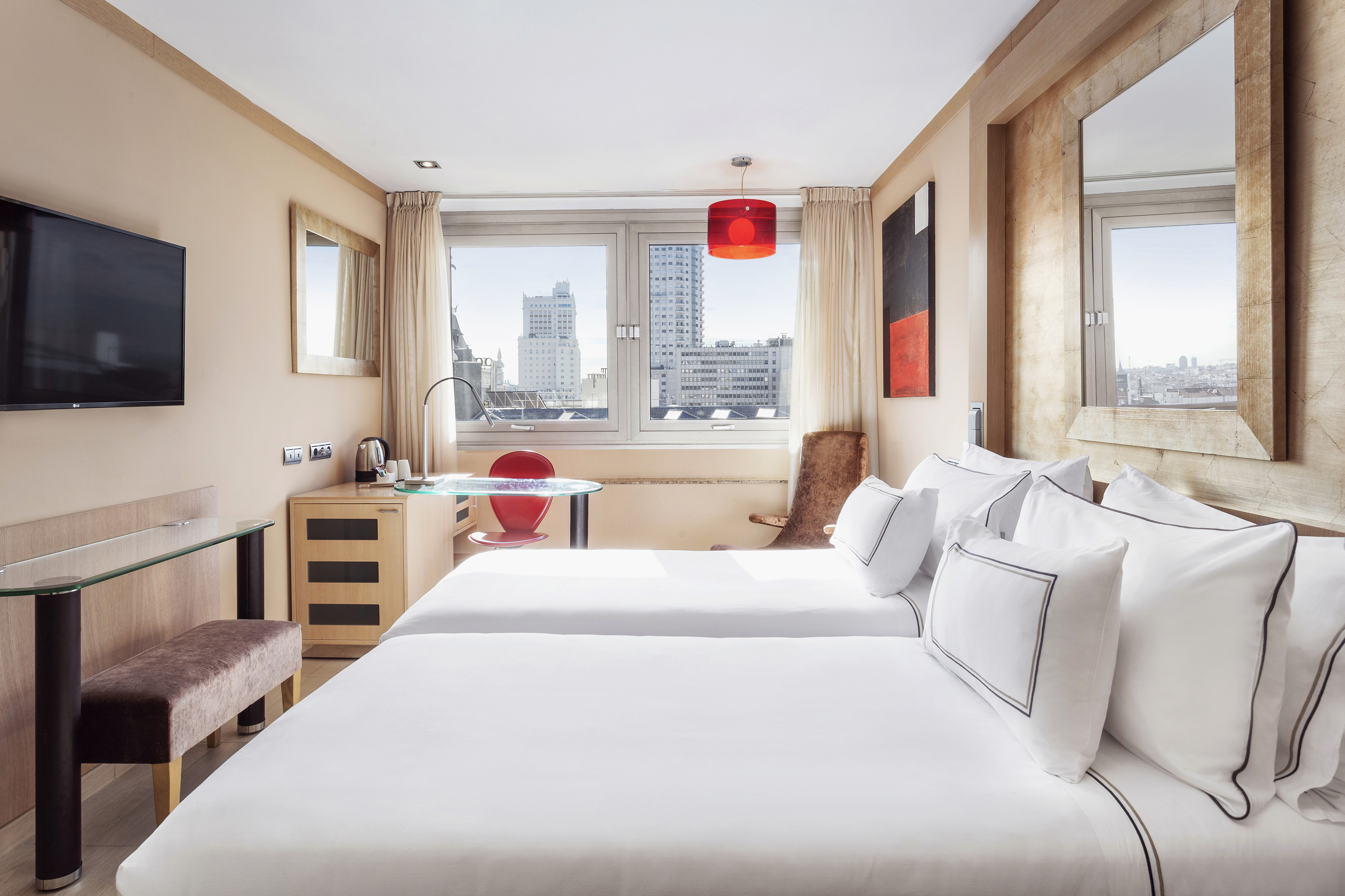 a room with two beds and a table