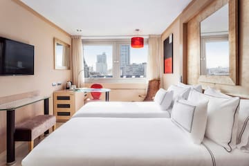a room with two beds and a table