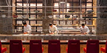 a group of people cooking in a restaurant