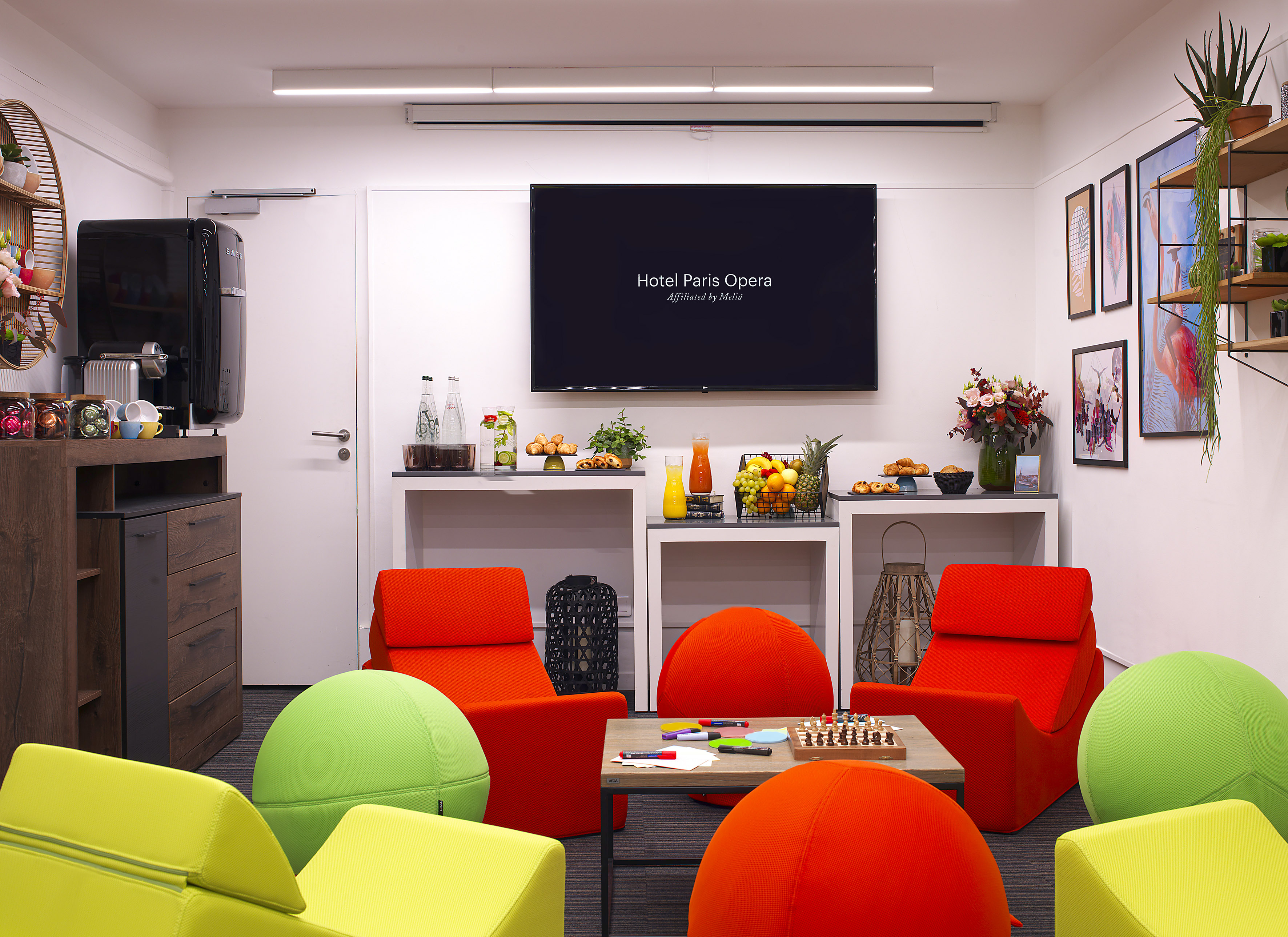 a room with colorful chairs and a tv