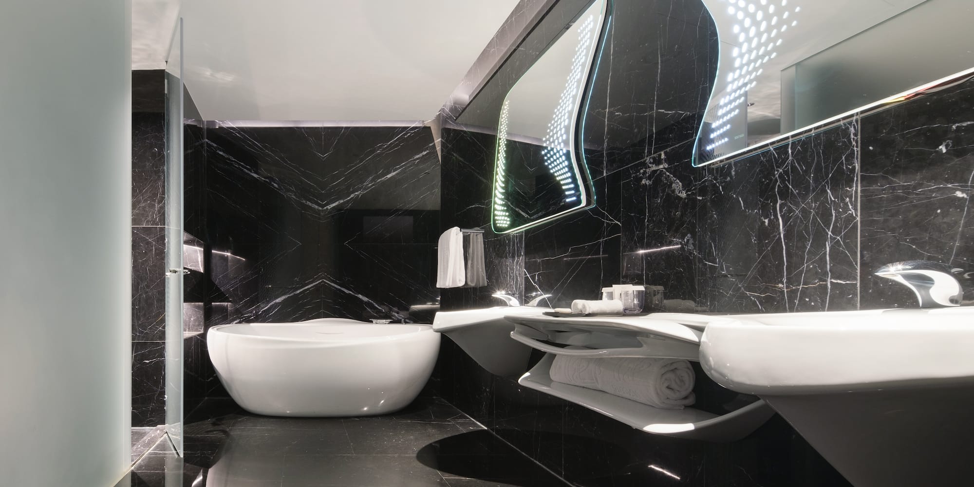 a bathroom with a tub and sinks