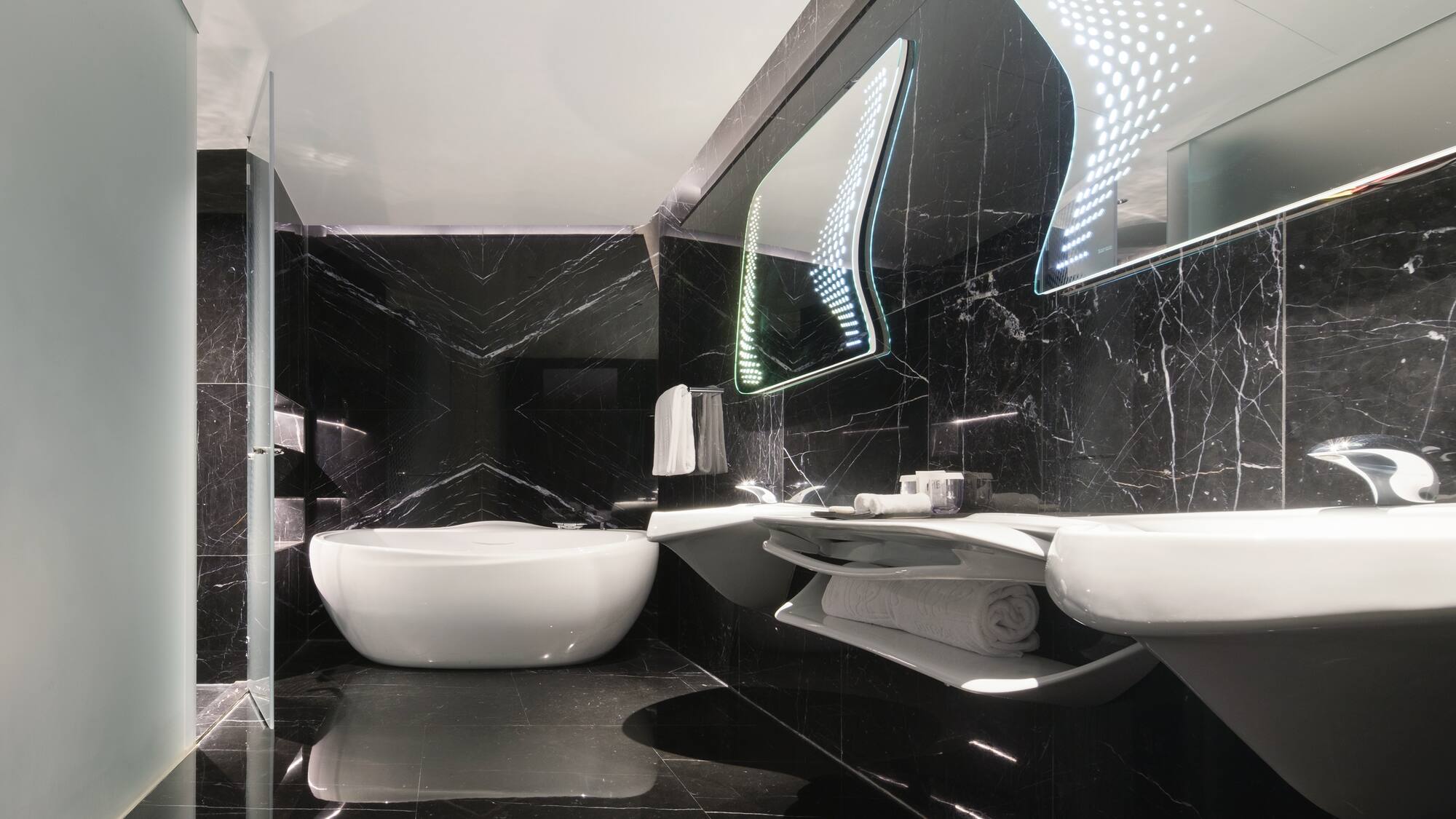 a bathroom with a tub and sinks