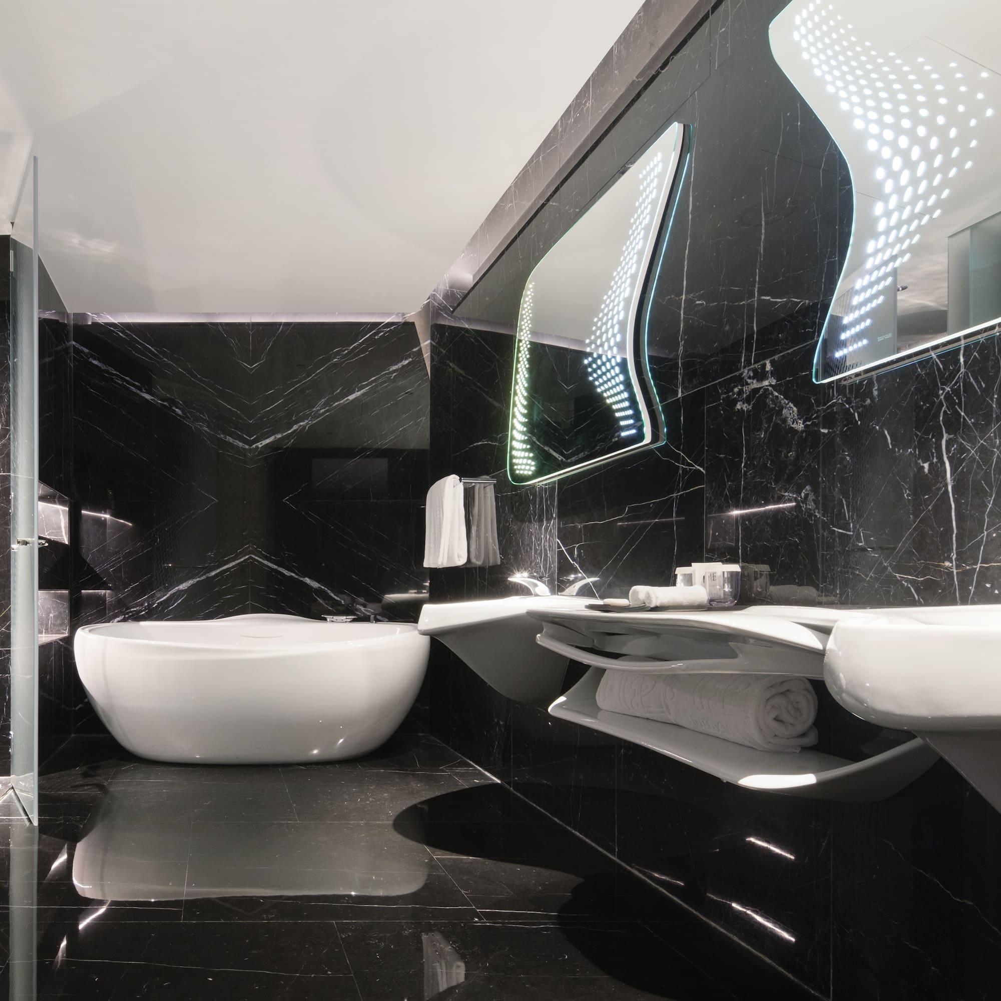 a bathroom with a tub and sinks