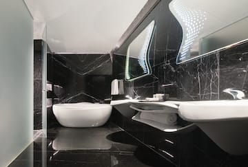 a bathroom with a tub and sinks