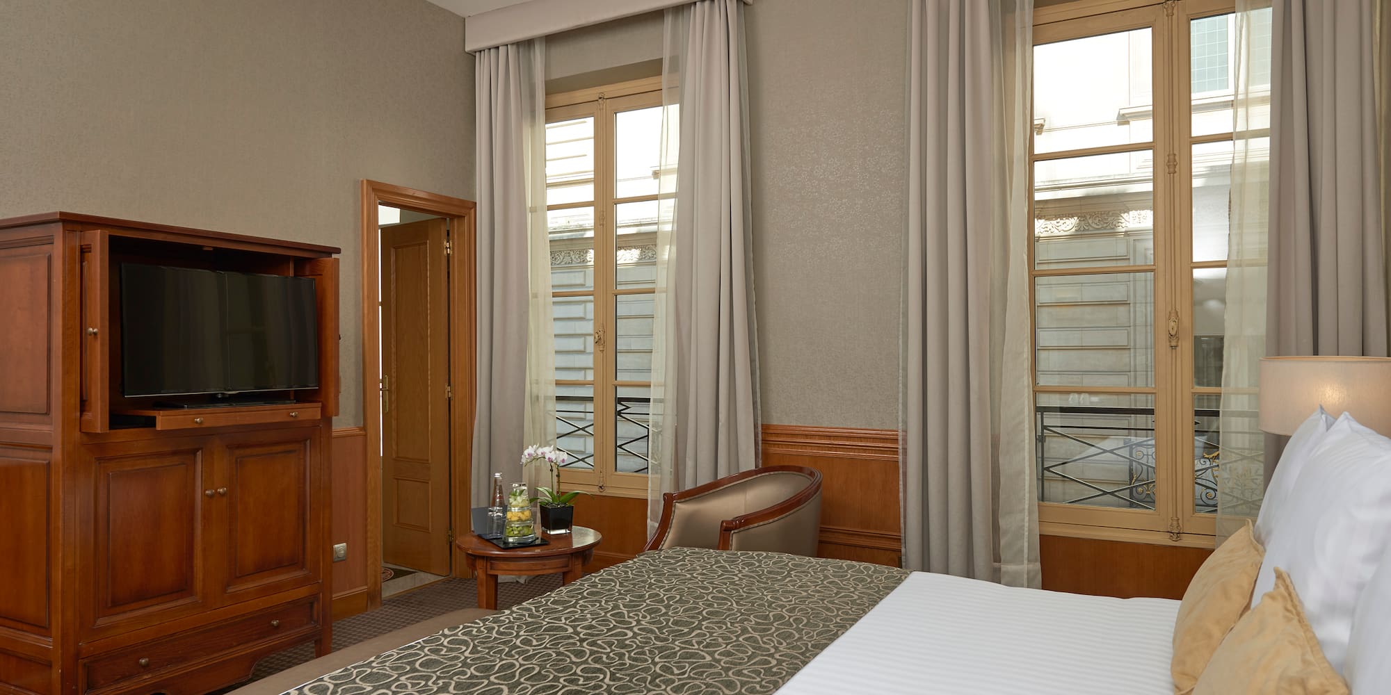 a room with a bed and a television