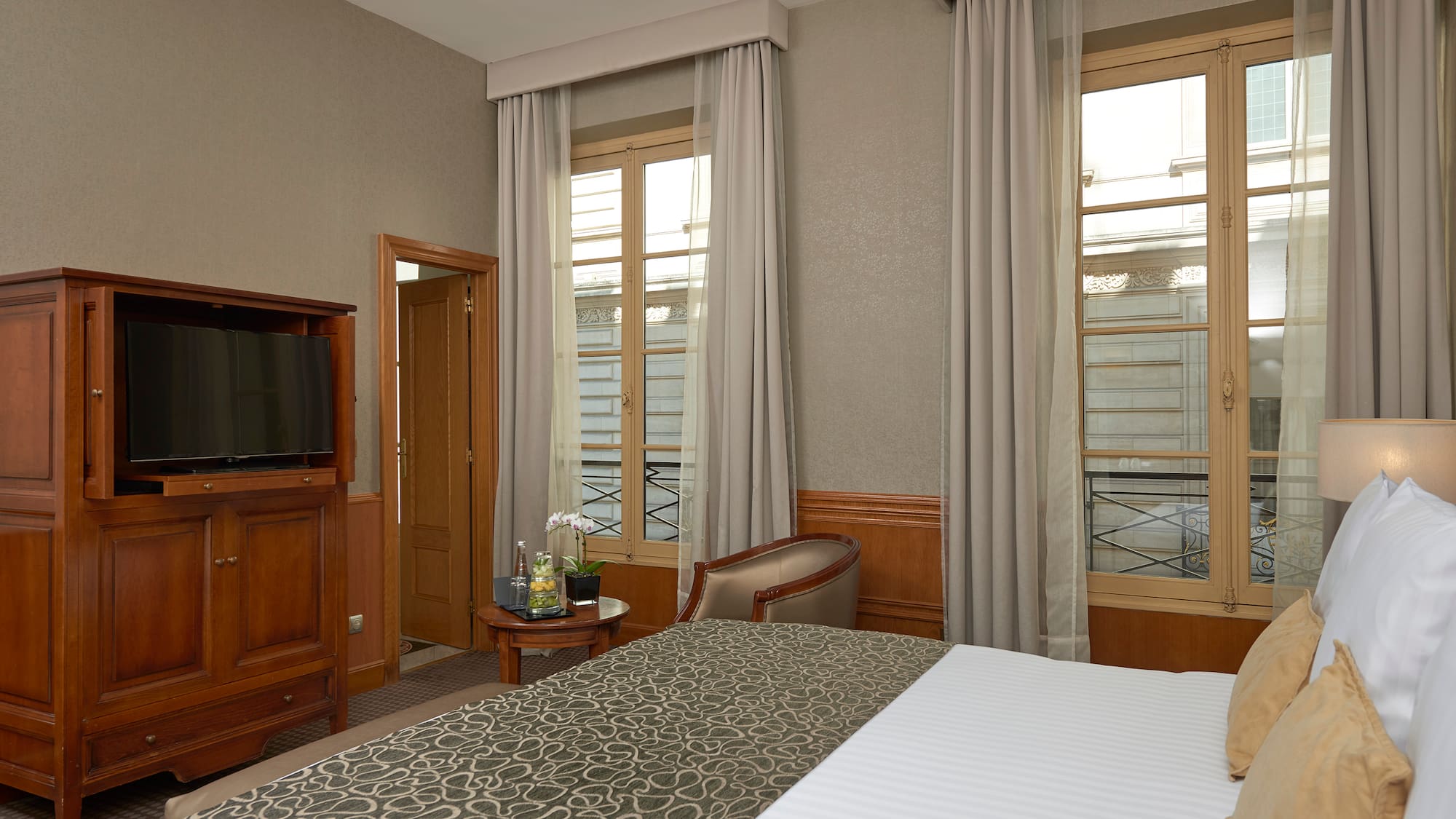 a room with a bed and a television