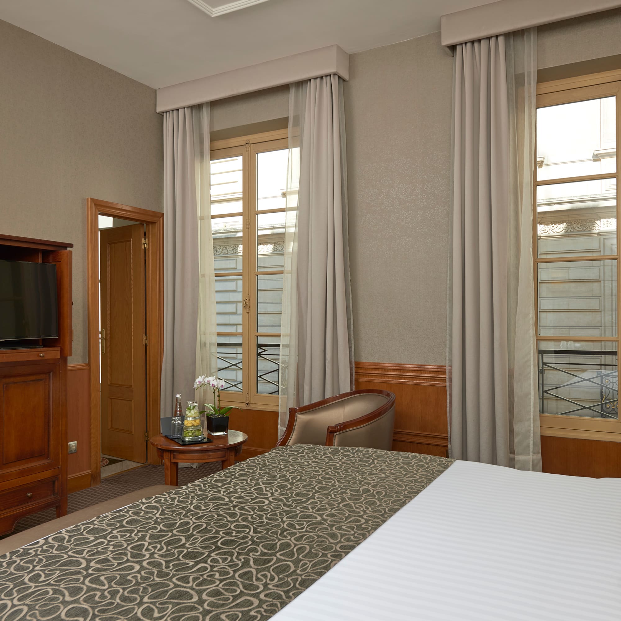 a room with a bed and a television