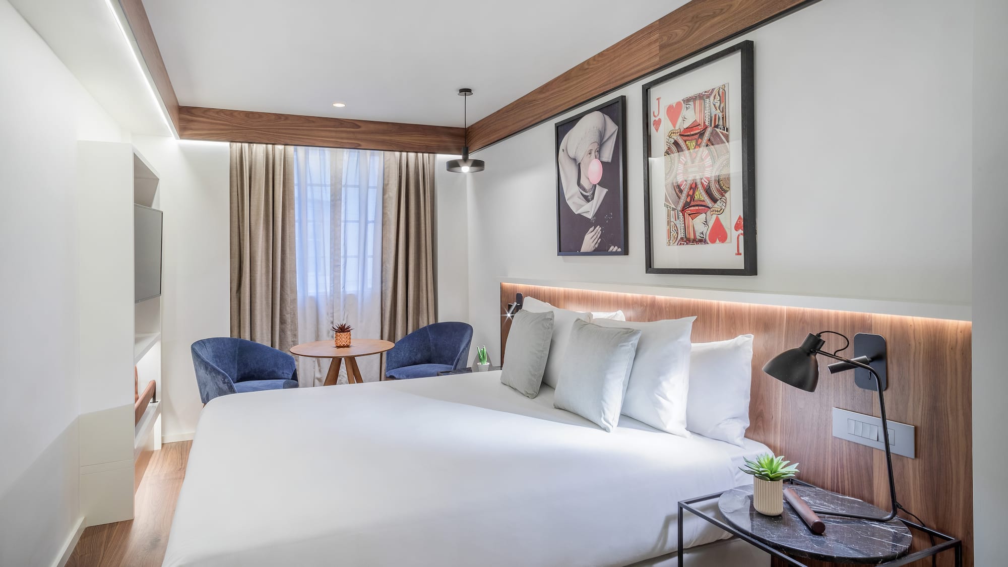 a bed with a table and chairs in a room