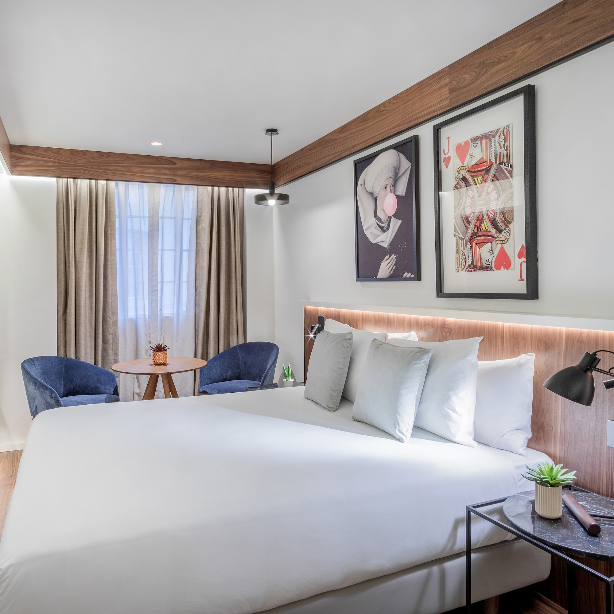 a bed with a table and chairs in a room