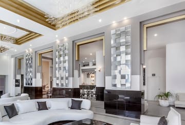 a room with a white couch and black and white walls