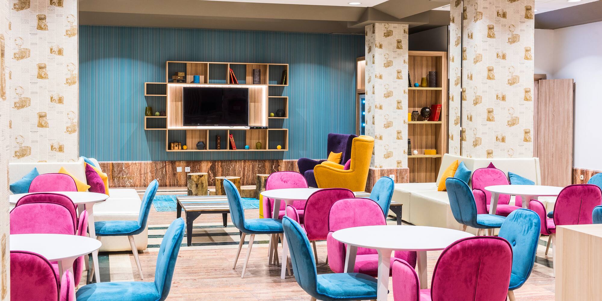 a room with colorful chairs and tables