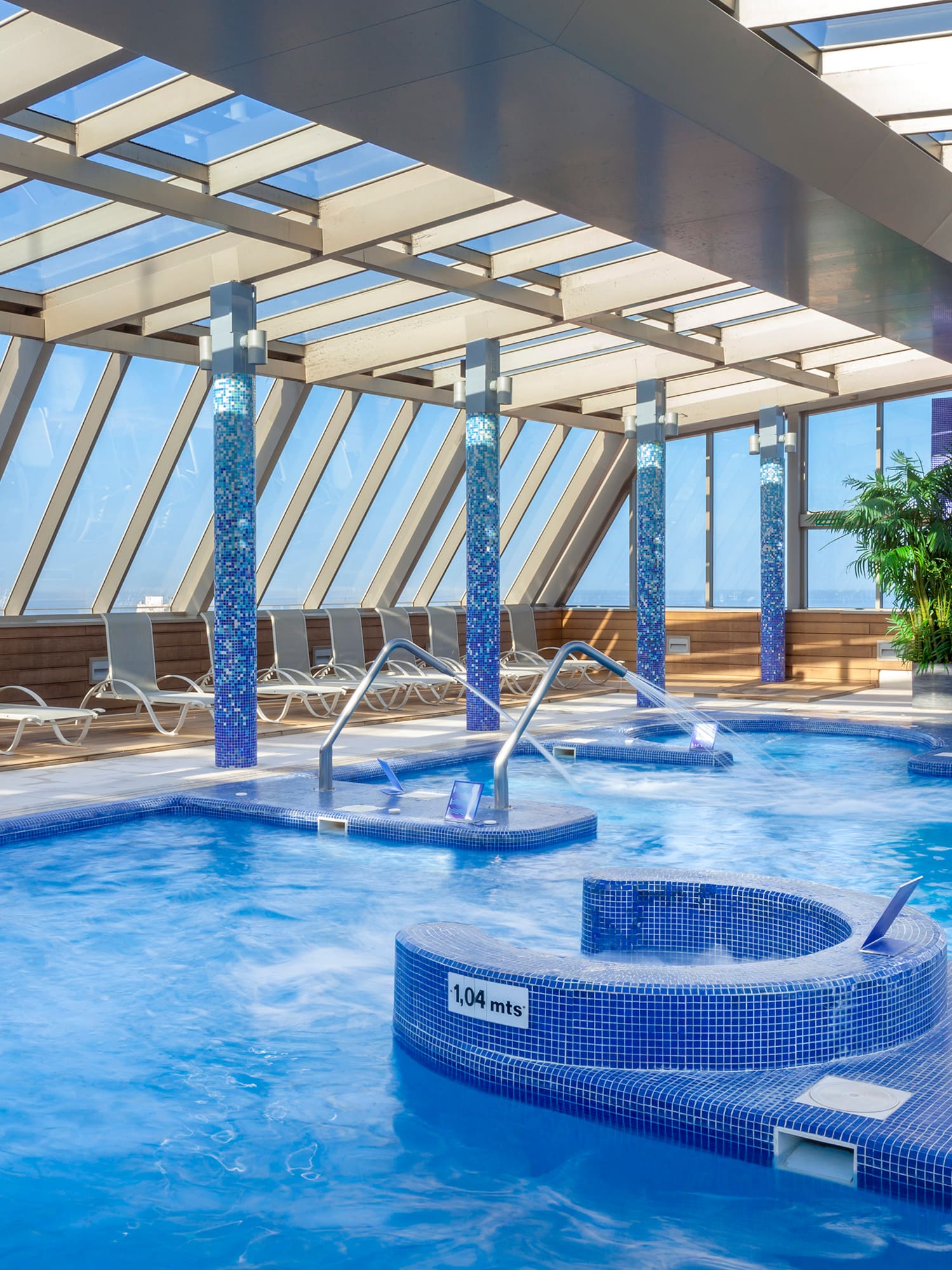 a swimming pool with hot tubs and chairs