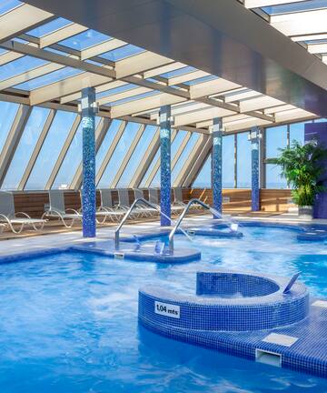 a swimming pool with hot tubs and chairs