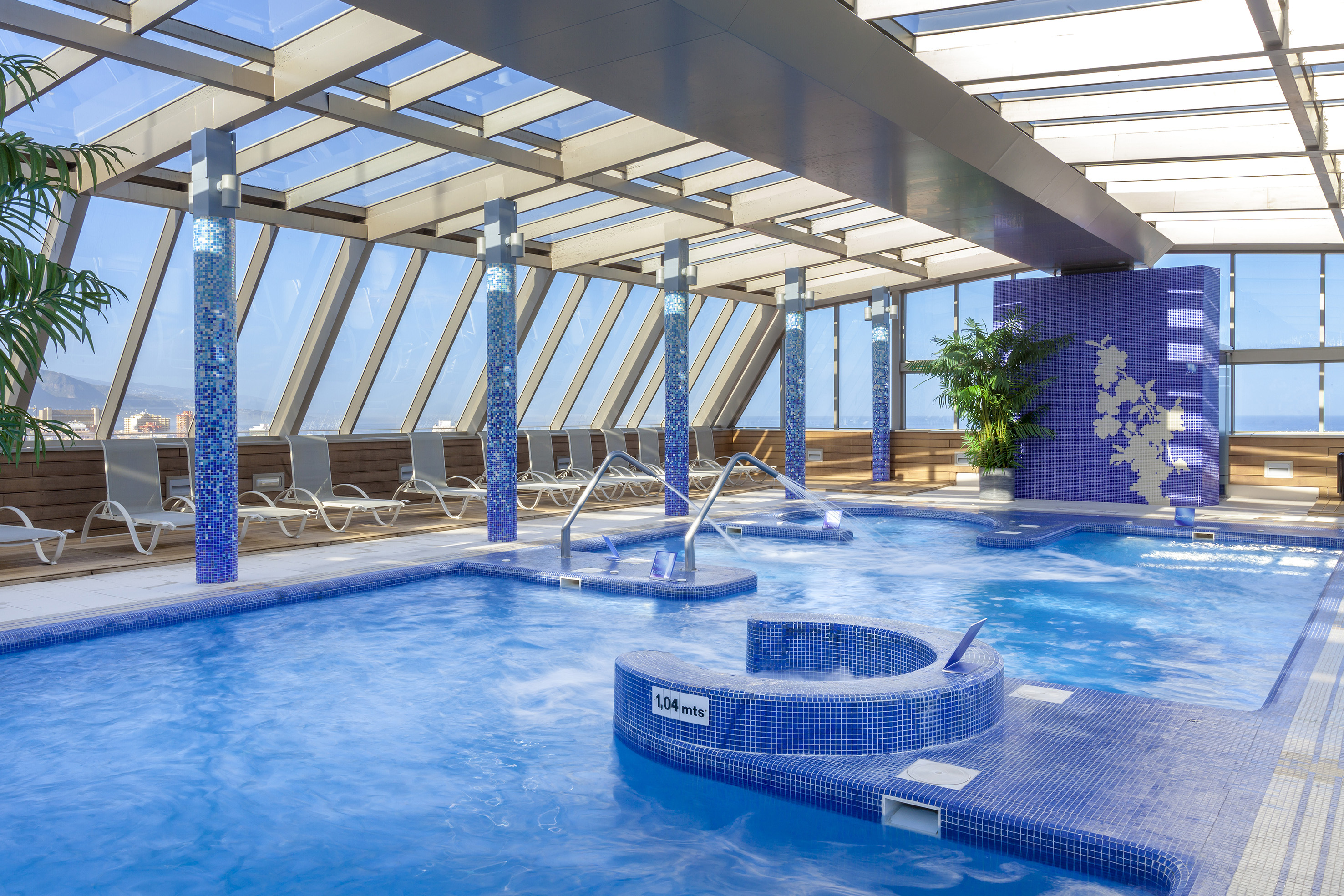 a swimming pool with hot tubs and chairs