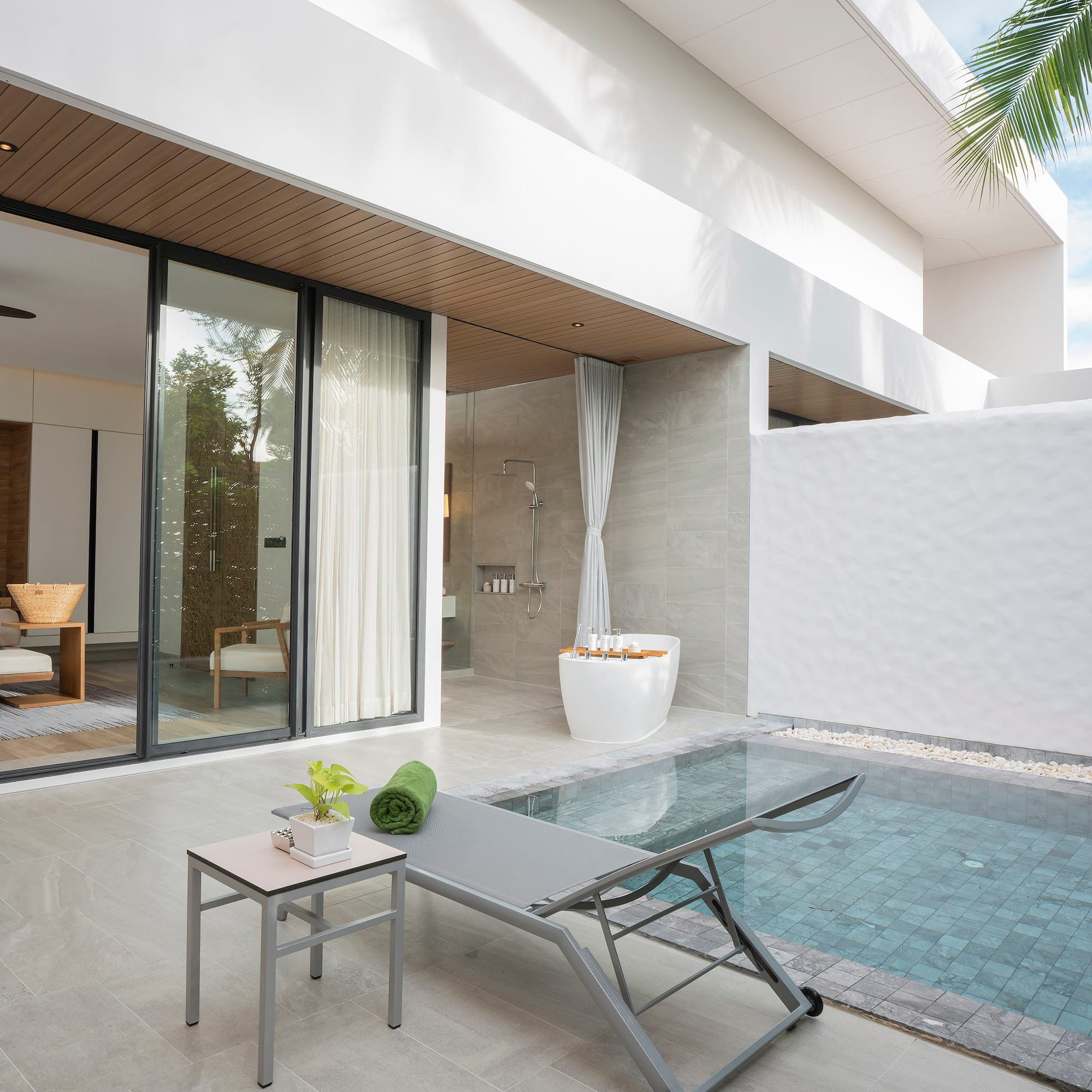 a pool and lounge chair in a house