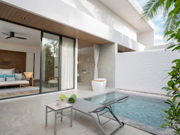 a pool and lounge chair in a house