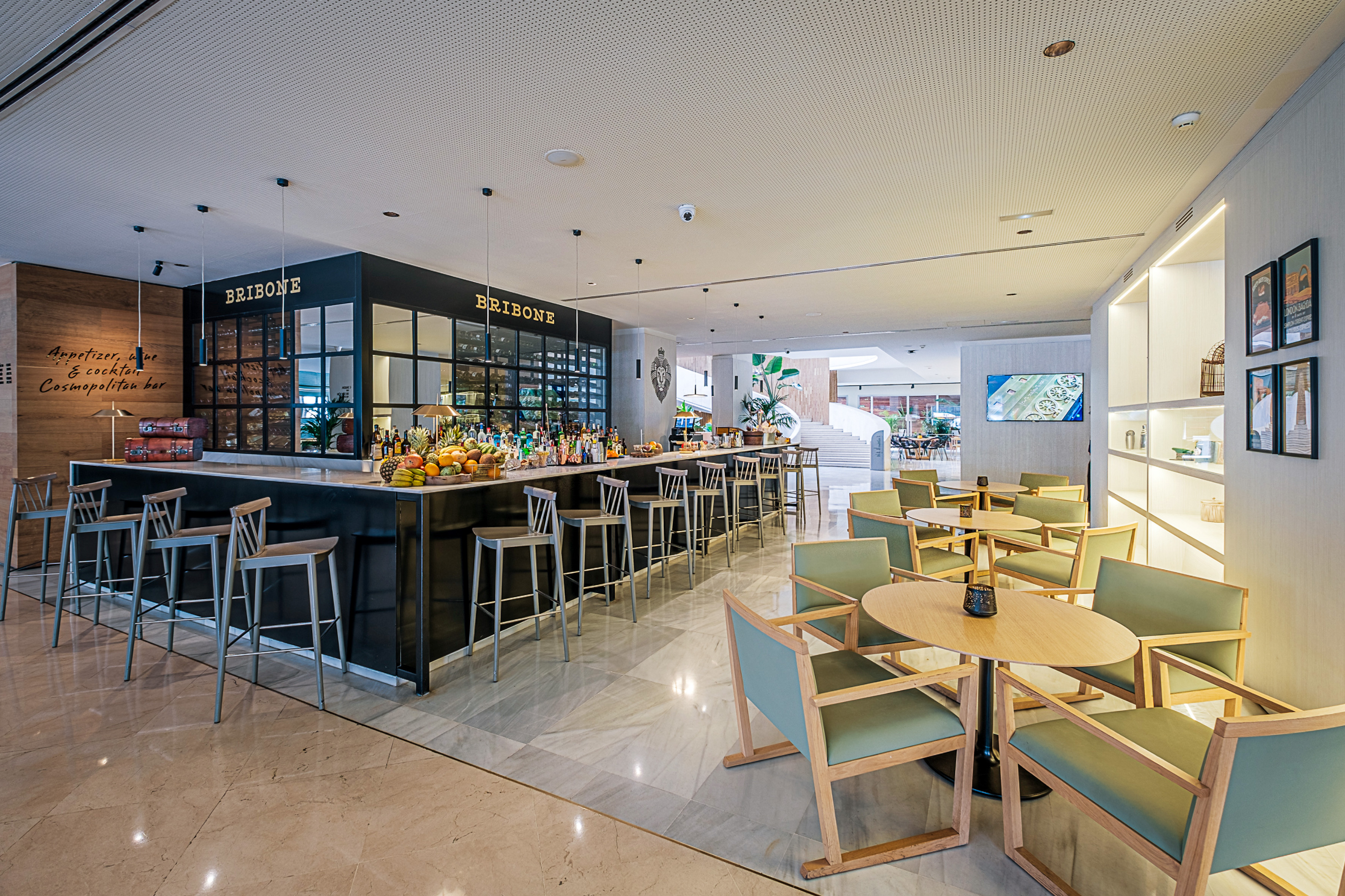 a room with a bar and chairs