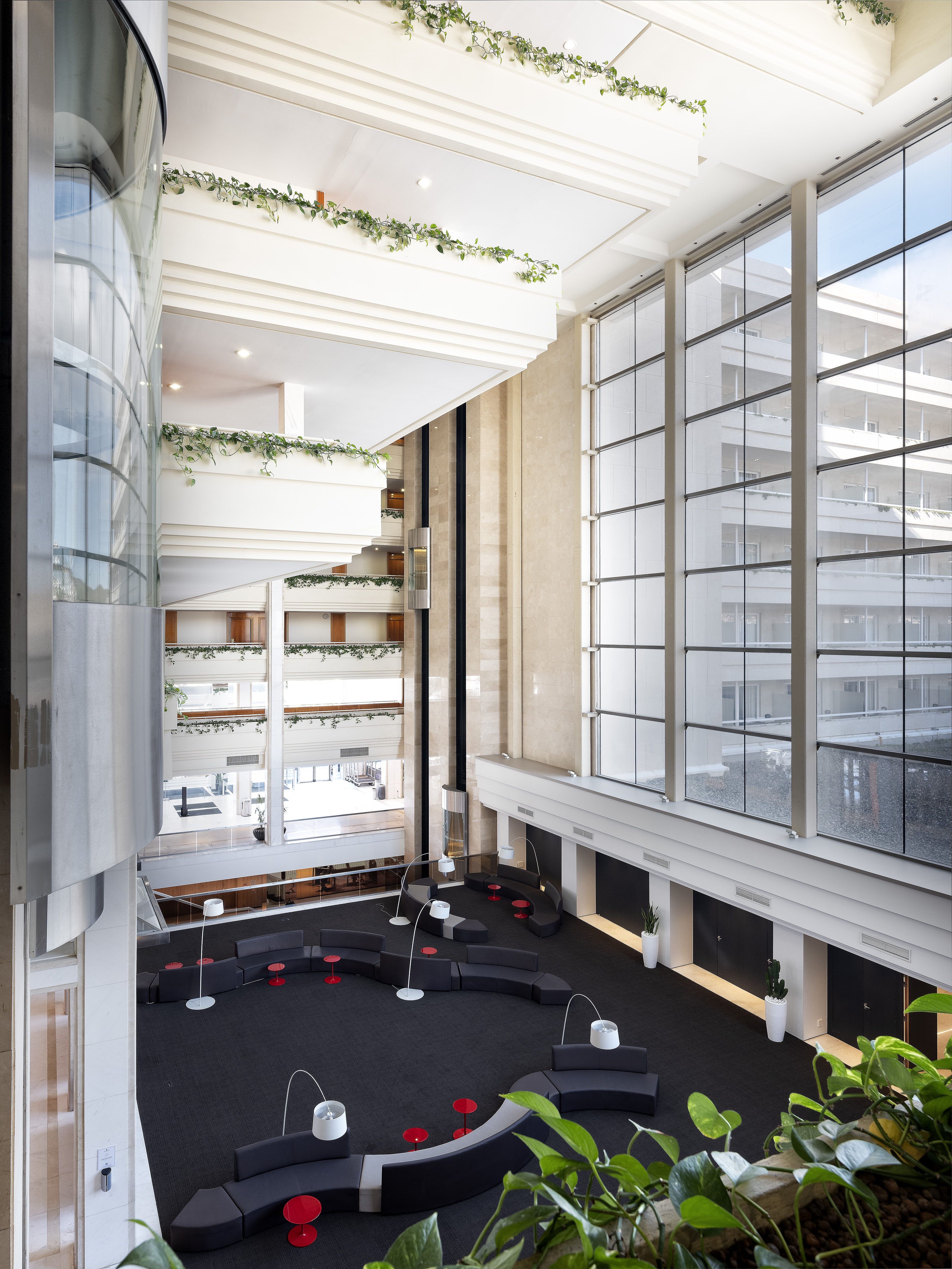 a large building with a large staircase and a black couch