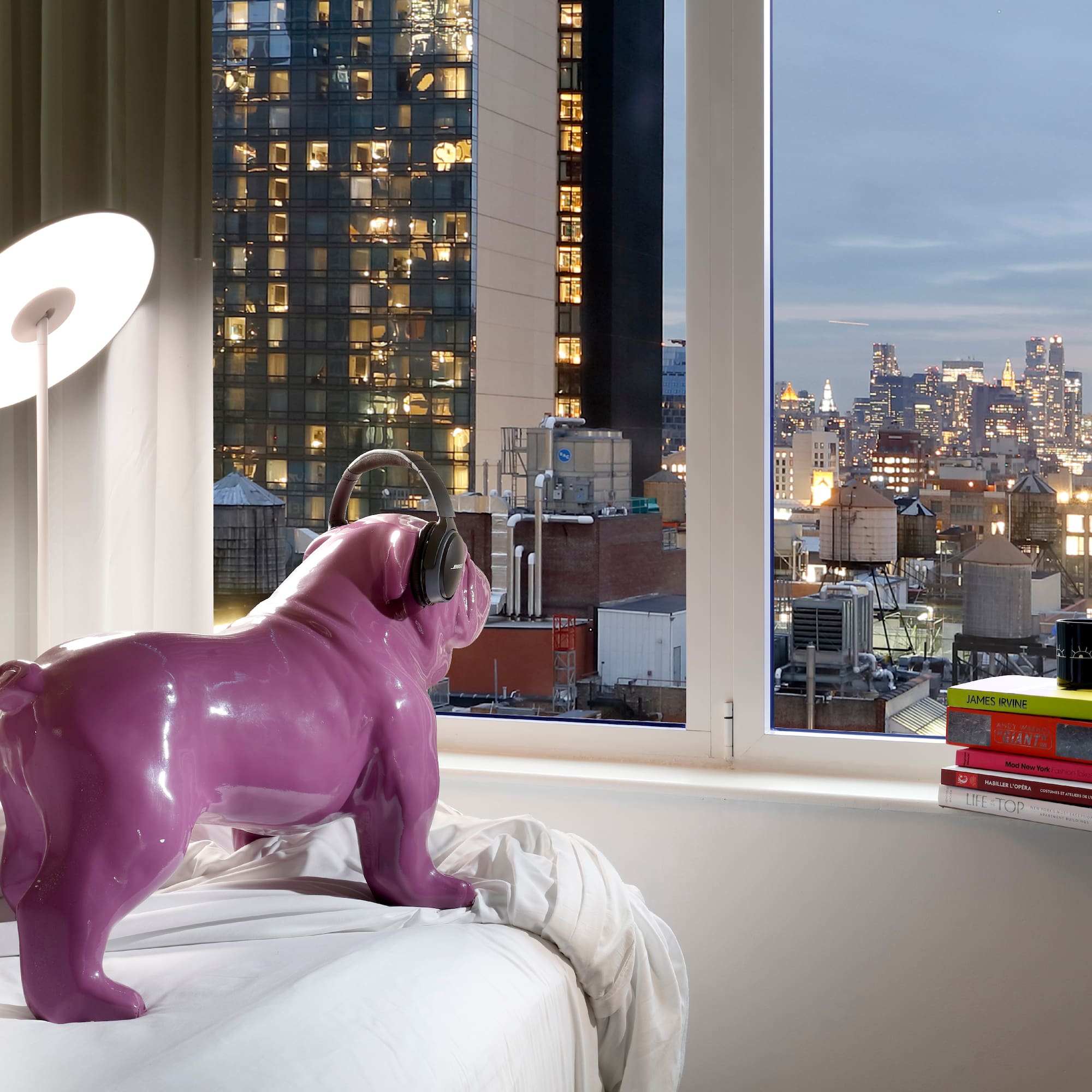 a purple dog statue on a bed