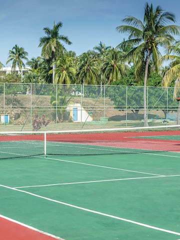 a tennis court with a red roof and a red gazebo