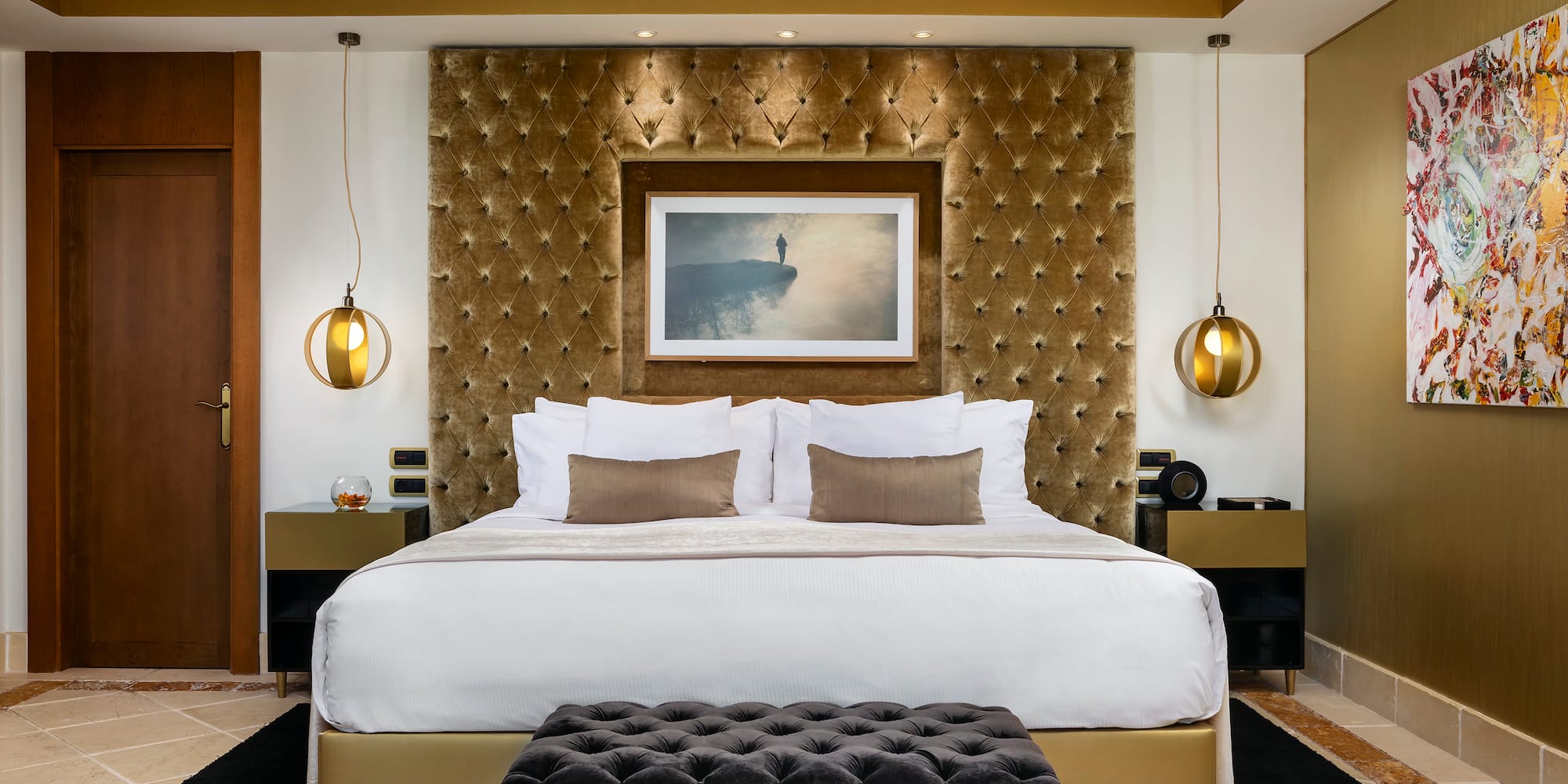 a bed with a picture above it