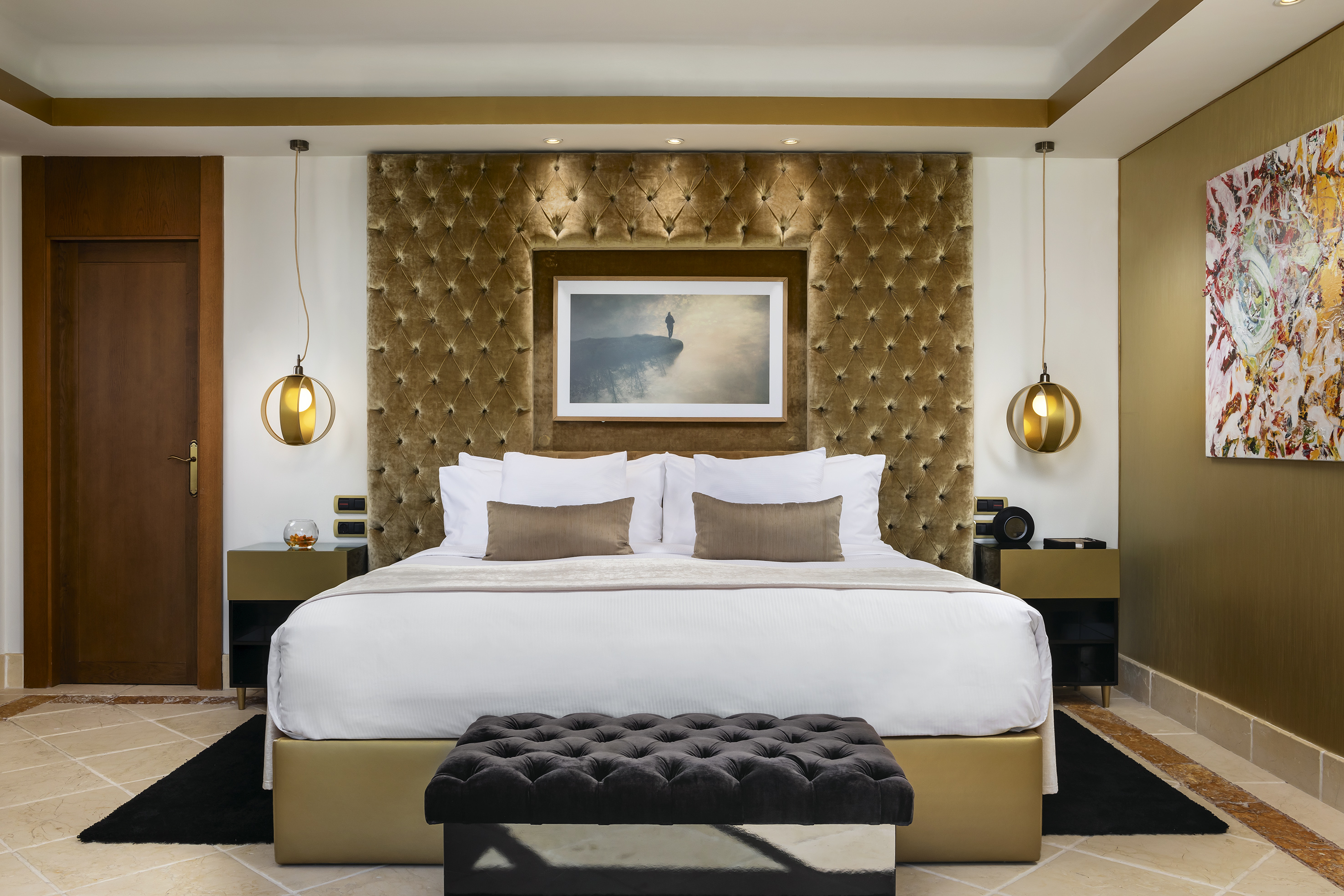 a bed with a picture above it