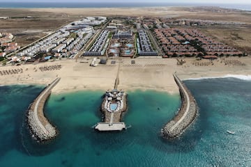 a beach with buildings and a body of water