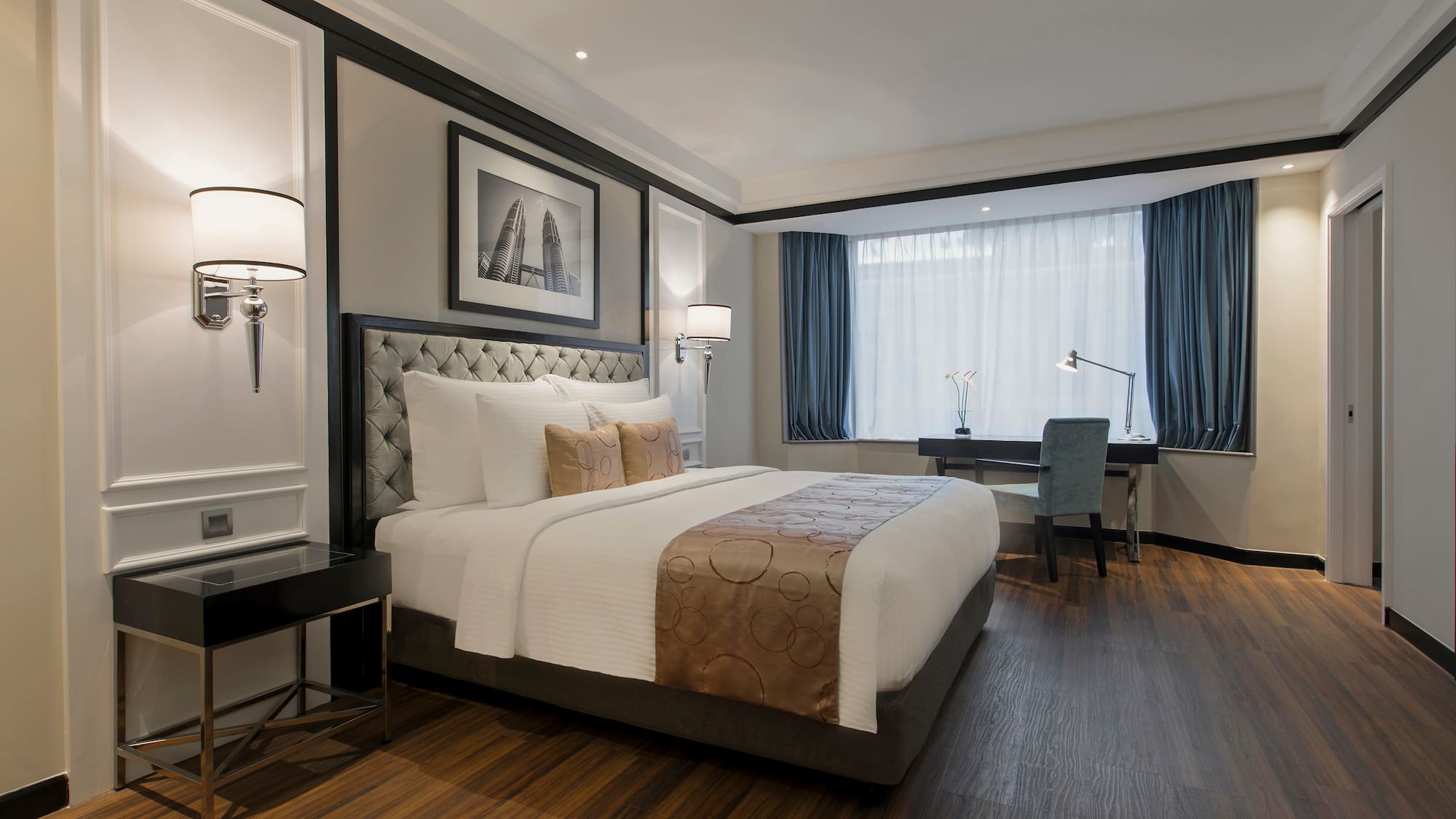 a bedroom with a desk and lamp