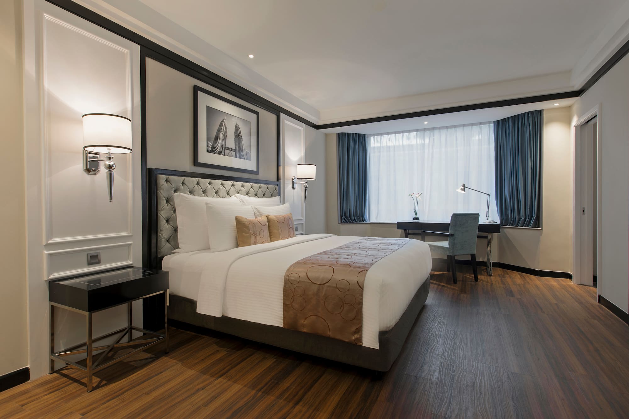 a bedroom with a desk and lamp